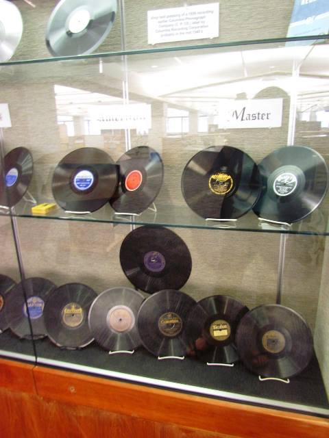 A displace case filled with vinyl albums.