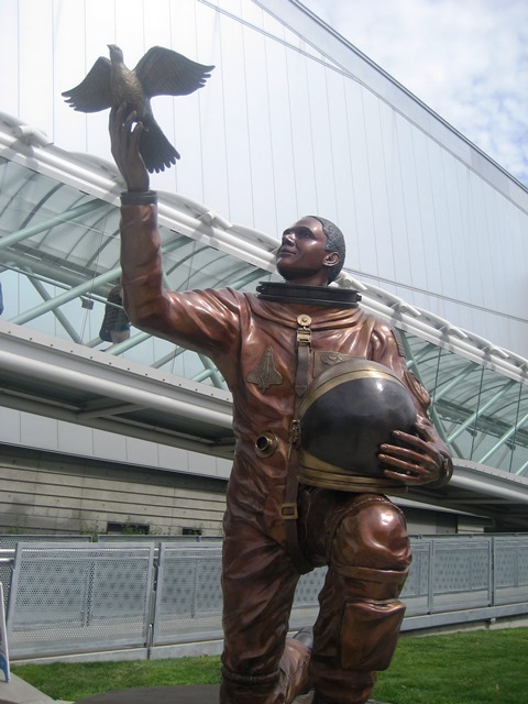 Michael P. Anderson statue outside the Museum of Flight in Seattle, Washington.

Bronze statue has Michael dressed in his spacesuit, kneeling on one knee. He is balancing his helmet on his left knee, while he holds up a dove preparing to fly from his right hand. He has a peaceful look as he looks up to the sky.