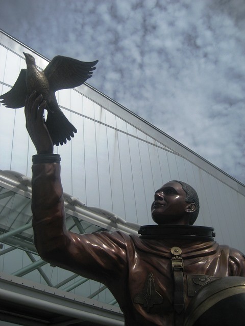 Bronze statue of Lt. Col. and astronaut Michael P. Anderson as he looks up  and holds a dove to the skies.