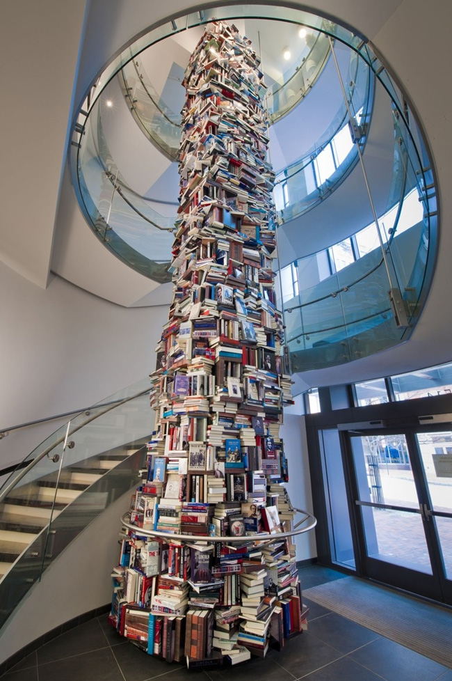 Tower of books stacked three floors high.