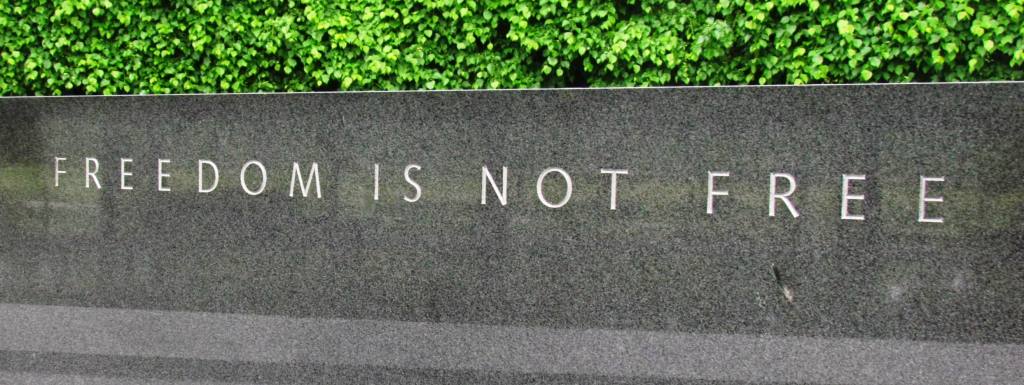 Marbled wall with the words "Freedom is not free" etched into it.