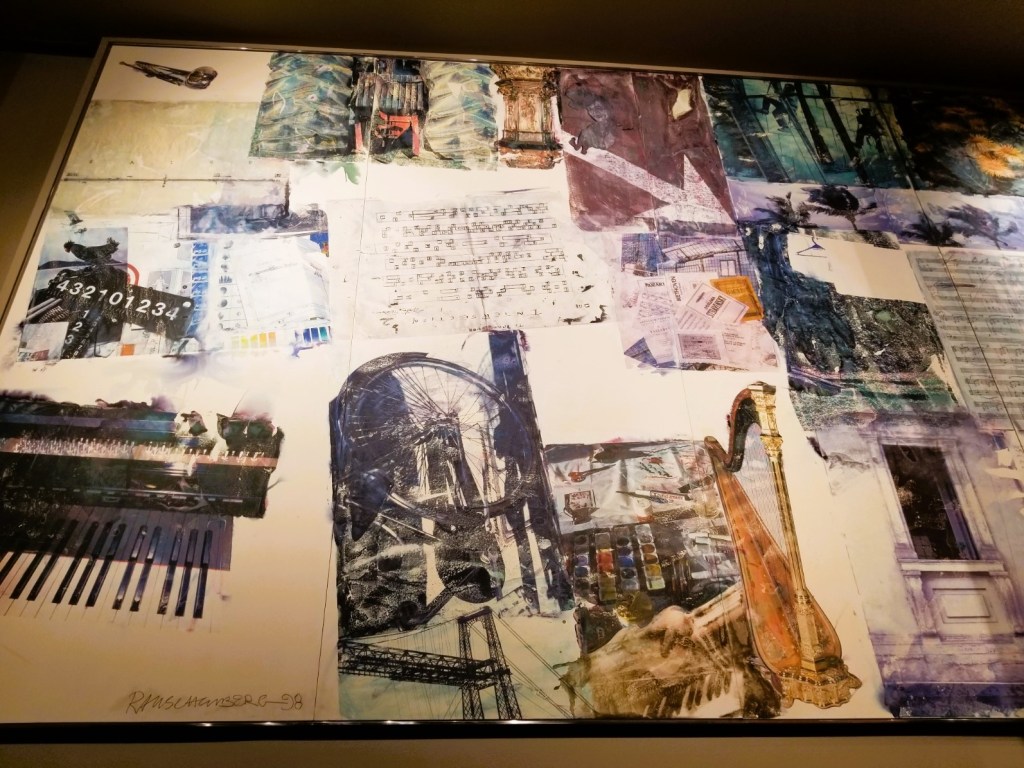 A mural on the wall before entering the doors into the symphony hall. Assorted instruments, music and numbers all about. The piece is called "Echo" - created by Robert Raushenberg