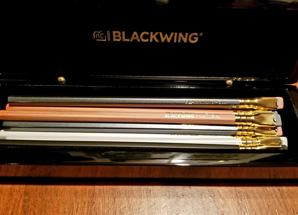 A Blackwing pencil box filled with assorted unsharpened pencils